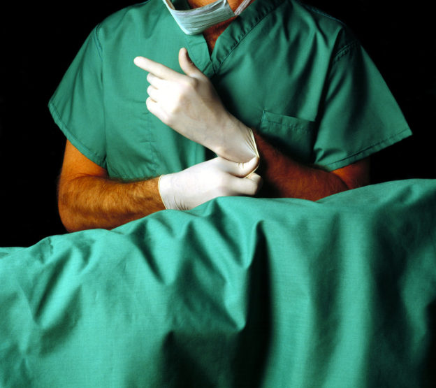 surgeon putting on gloves, how to avoid colonoscopy exam